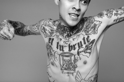Young dude heavily inked with black and white tattoos. [via.