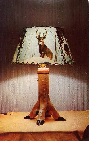 WORLD&#8217;S TACKIEST LAMPS—PART 1
DEER HOOF LAMP
No description on this card.
Question is, are they real deer hooves? I say yes.
On the internet I found:— Instructions on how to make a deer hoof gun rack— You can purchase a deer hoof coat rack (the lower portion of the deer&#8217;s leg, bent at the joint, and attached to a log)— A seller on eBay currently has a &#8220;VINTAGE VICTORIAN DEER HOOF PIN CUSHION, NICE&#8221; with a Buy-It-Now of $69.99— A deer hoof bottle opener from a German souvenir website
Reuse. Recycle.
NEXT:  Is this man possessed???