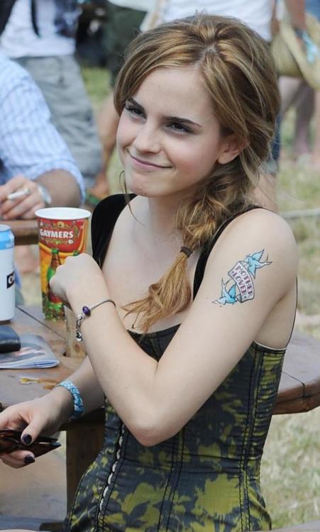 Emma Watson proudly showing off her bad ass tattoo lol