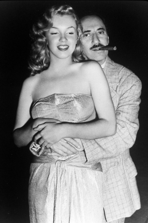 Groucho Marx holding on to a young Marilyn Monroe via 