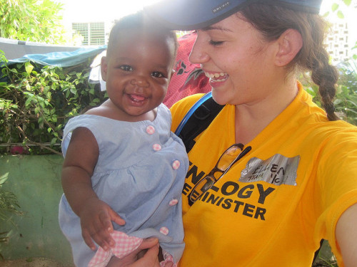 A Scientology Volunteer Minister enjoys a moment with a baby in Haiti.