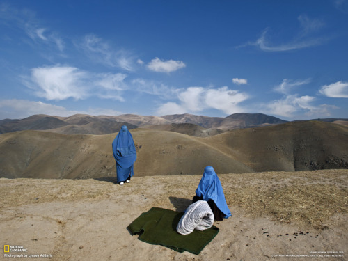 Afghan Women
Photograph by Lynsey Addario.

&#8220;I saw two women on the side of the mountain, in burkas and without a man. In Afghanistan you seldom see an unaccompanied woman. Noor Nisa, about 18, was pregnant; her water had just broken. Her husband, whose first wife had died during childbirth, was determined to get Noor Nisa to the hospital in Faizabad, a four-hour drive from their village in Badakhshan Province. His borrowed car broke down, so he went to find another vehicle. I ended up taking Noor Nisa, her mother, and her husband to the hospital, where she delivered a baby girl. My interpreter, who is a doctor, and I were on a mission to photograph maternal health and mortality issues, only to find the entire story waiting for us along a dusty Afghan road.&#8221; - Lynsey Addario