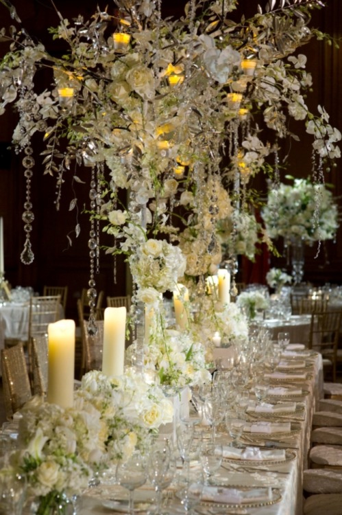 Twinkling lights crystals white roses and candles complete this gorgeous 