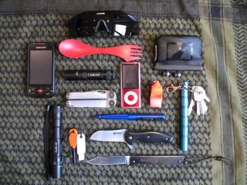 submitted by flecktarn

My EDC
CRKT TUITION
Cognet DOUK-DOUK (French knife)
Fenix LD10
Fenix L2D
Leatherman Wave
Ipod Nano + Sennheiser earbuds
Fox 40 Sonic Blast whistle
Swith & Wesson tactical pen
Light my fire Firesteel
Light my fire Spork
Kubotan Keychain
ESS ICE glasses
Smartphone
Not on the picture a king cobra paracord bracelet (I forgot to take it out of my wrist)
PS: Thanks for your awesome blog!

Editor’s Note: Looks like a very hefty load out, but you’d be prepared for most… If you had to, I feel like you could ditch/swap one of the lights out, as the LD10 and L2D are virtually the same light but with different runtimes/brightness.. You might find more versatility in a keychain light with a different beam profile, tint, method of activation, etc. The two Fenixes seem redundant as a primary/backup set. Otherwise, nice carry — the Douk-Douk and kubotan look neat and all that color is less threatening while offering visibility. Thanks for sharing~