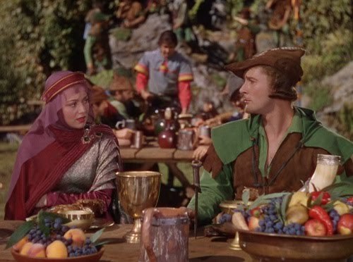Feb. 11, 2011<br />36. The Adventures of Robin Hood (1938) &#8212;REWATCH<br />Starring Errol Flynn, Olivia de Havilland, Basil Rathbone, Claude Rains<br />Directed by Michael Curtiz &amp; William Keighley<br />Plot: &#8220;When Prince John and the Norman Lords begin oppressing the Saxon masses in King Richard&#8217;s absence, a Saxon lord fights back as the outlaw leader of a rebel guerrilla army.&#8221;<br />I&#8217;d seen this film a few years ago, but that was before I really got into old movies. This is clearly one of the most BEAUTIFUL films ever made. The vivid Technicolor jumps off the screen and the costumes and atmosphere are a feast for the eyes. The film boasts a perfectly-cast set of characters plucked from the talented group of Warner Brothers contract players. As for the story itself, it is pure escapist entertainment. Filled with duels, a dashing hero, a fair maiden, humorous sidekicks and calculating villains, it&#8217;s a storybook perfect fairytale.  This is the second of eight films that Olivia de Havilland and Errol Flynn made together (that was mainly the reason I wanted to rewatch it!). My one regret with this film is that they left out the ending scene of the couple riding off into the sunset. 