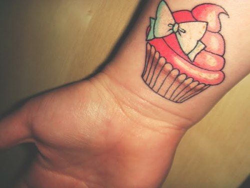 What a sweet cupcake tattoo I love the bow detail