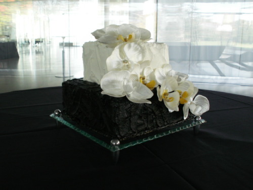 Flowers with dirty iced tuxedo wedding cake by Cherry Lane Custom Cakes