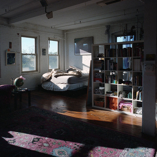 possibly my dream room oh god i want to live somewhere like this and have a beautiful open, light, sunny space, and a massive white bed with white sheets, and open brick walls and lots of awesome books and movies and records and ugh it&#8217;ll be perfect.