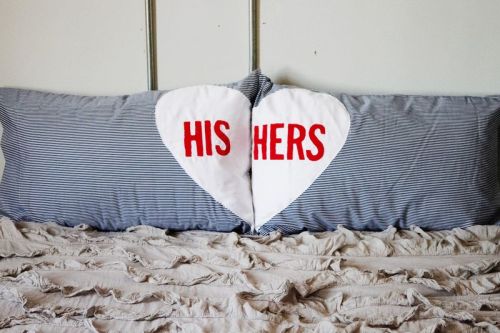 DIY His & Her’s Pillow Cases
(via a beautiful mess)
Supplies: Pillow cases, red and white cotton fabric, adhesive letters. You will also need to have scissors, sewing pins and a sewing machine!
1. First, cut a large heart out of the white fabric. Make sure it’s not bigger than your pillow case! We made our heart wider than normal because when the pillow is in the case it tends to make it bulge, making it look less wide.
2. Next, apply the adhesive letters. You can buy a pack of letters at your local craft store, or make your own out of contact paper!
3. Once you’ve applied the lettering, flip the heart over, facing down. Begin pinning large squares of the red fabric on the back. This will be the background of the lettering so be sure that all of the adhesive letters have fabric behind it.
4. Next, slowly stitch around all of the adhesive lettering, sewing together the red and white fabric.
5. Once you’ve sewn around all the lettering, remove the contact paper!
6. Next, you’ll slowly cut out each letter. Make sure you only cut through the top layer of fabric!
7. Lastly, cut the heart down the middle and sew it to the pillow case! We used a simple top stitch close to the edge of the fabric to prevent as much fray as possible.